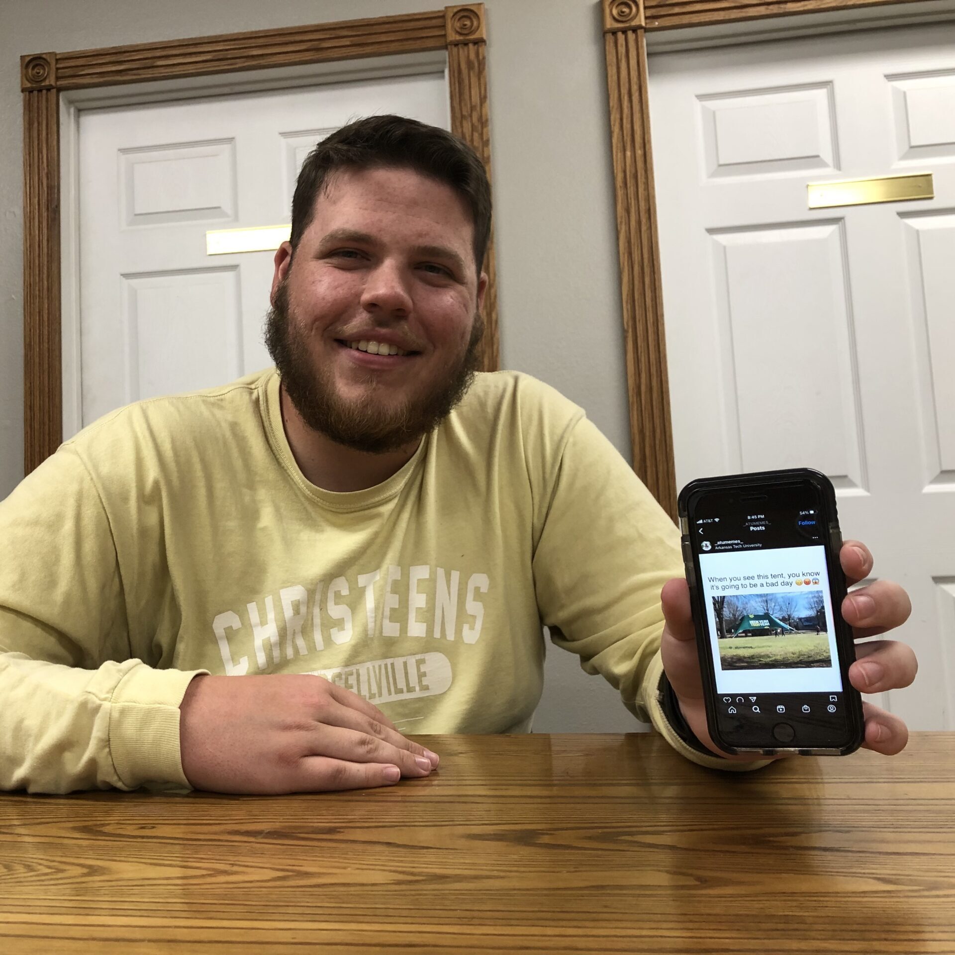 ATU Student Holding His Favorite Meme