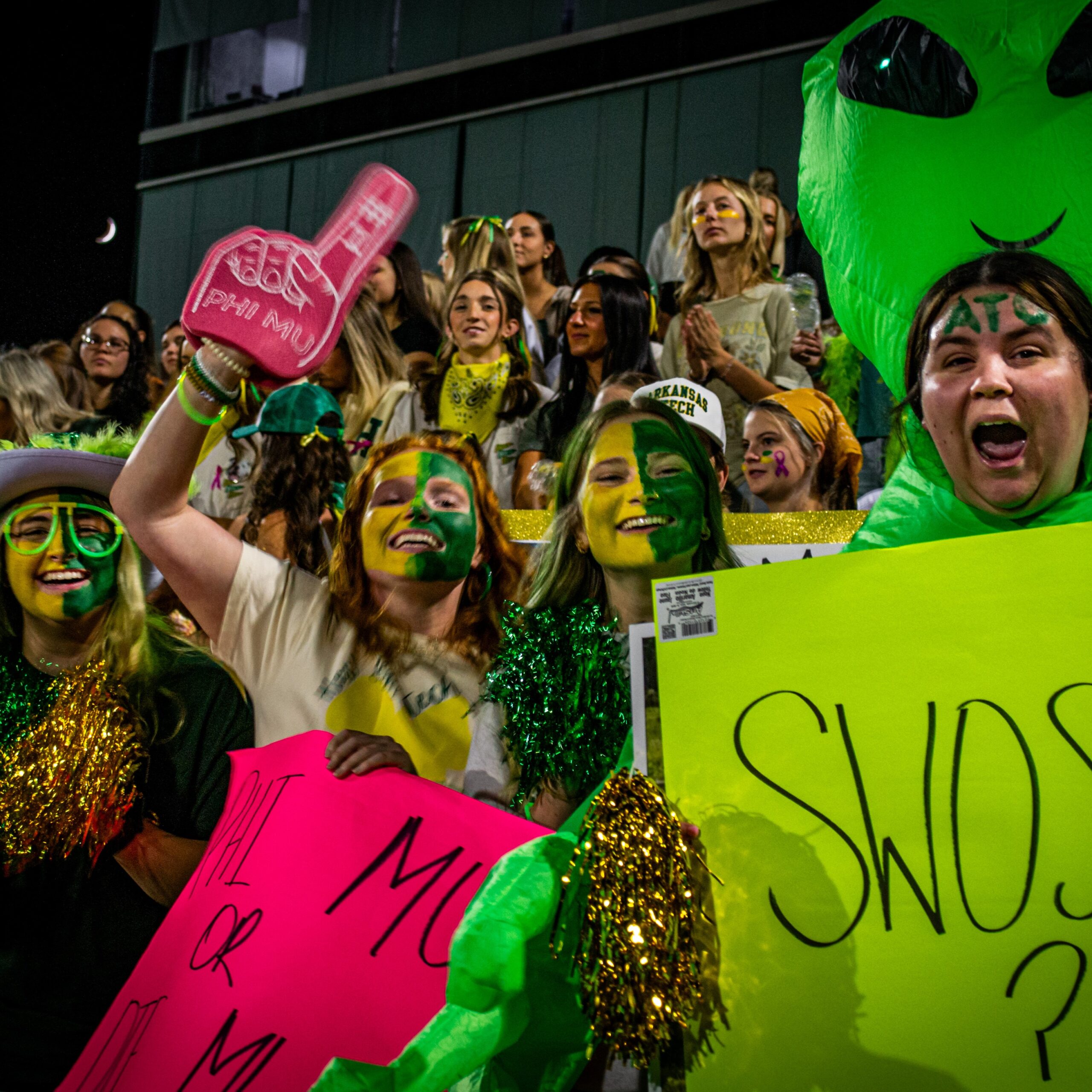 Phi Mu showing their school cheer at the pep rally